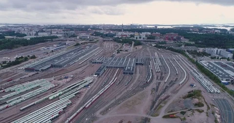 Aerial drone view of train yard with lots of train, railroads and warehouses. Stock Footage 79808126