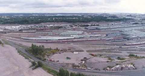 Aerial drone view of train yard with lots of train, railroads and warehouses. Stock Footage 79808356