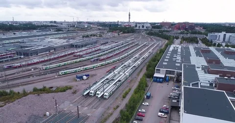 Aerial drone view of train yard with lots of train, railroads and warehouses. Stock Footage 79808613