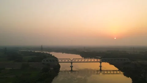 Aerial drone view of a tranquil forest and river, bathed in the soft light of Stock Footage 299229827