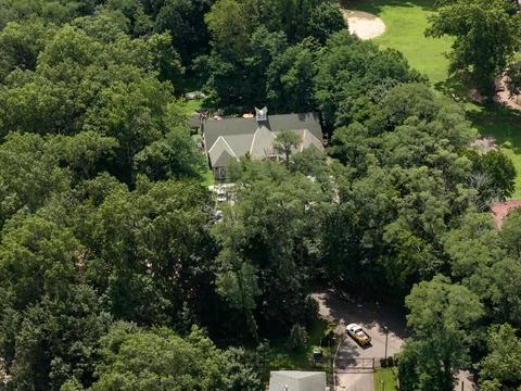 Aerial drone view of tree-lined residential neighborhood with detached homes 스톡 사진