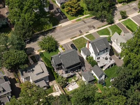 Aerial drone view of tree-lined residential neighborhood with detached homes 스톡 사진