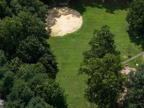Aerial drone view of tree-lined suburban intersection, nearby homes, and local Fotos de archivo