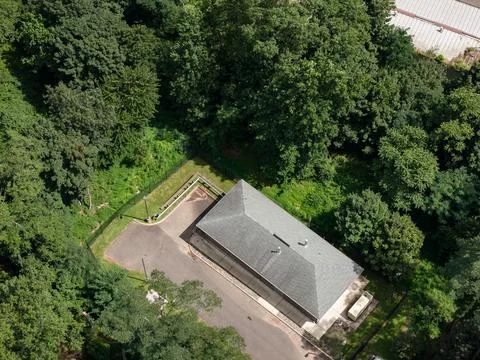 Aerial drone view of tree-lined residential neighborhood with detached homes Фото