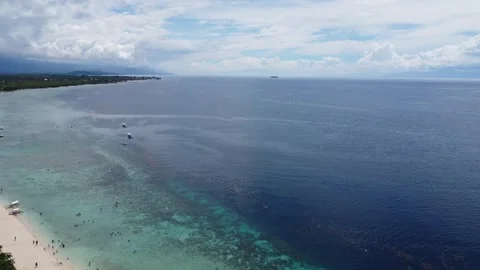 Aerial drone view of tropical White Beach in Moalboal Philippines with ocean Stock Footage 335394866