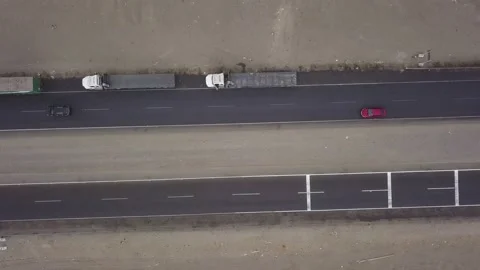 Aerial drone view of trucks on the side of the road in bird's eye view on cloudy Stockbeeldmateriaal 197572340
