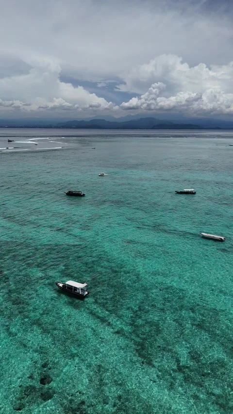 Aerial Drone View of Turquoise Lagoon and Boats near Nusa Ceningan Stock Footage 328718843