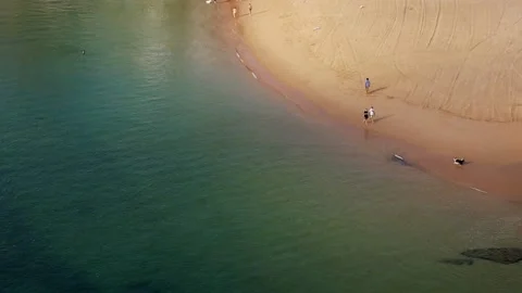 Aerial drone view of two unidentifiable older men chatting while strolling on Stock Footage 206744758