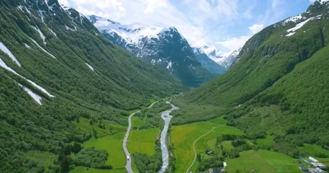 Aerial Drone View of Valley with River and Snow Capped Mountains (Norway) Stock Footage 247378264