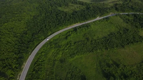 Aerial Drone View Van Driving on Curvy Mountain asphalt Road in summer Stock Footage 244544012