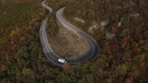 Aerial Drone View Van Driving on Curvy Mountain asphalt Road in autumn Video stock 254024407