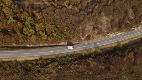 Aerial Drone View Van Driving on Curvy Mountain asphalt Road in autumn Stock Footage 254024757