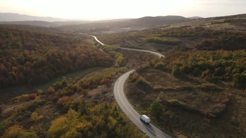 Aerial Drone View Van Driving on Curvy Mountain asphalt Road in autumn Stock Footage 254024883