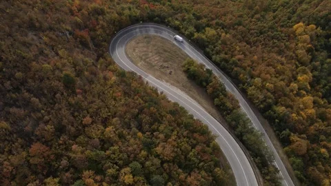 Aerial Drone View Van Driving on Curvy Mountain asphalt Road in autumn Stock Footage 254025175