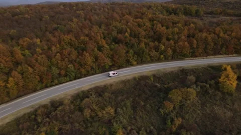 Aerial Drone View Van Driving on Curvy Mountain asphalt Road in autumn Stock Footage 254036536
