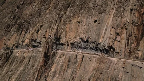 Aerial drone view of vehicle navigating the treacherous curves of Zojila Pass. Stock Footage 310806698