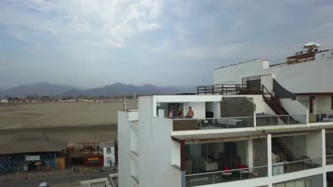 Aerial drone view walking away from several friends in the pool on the terrace o Stock Footage 195968026