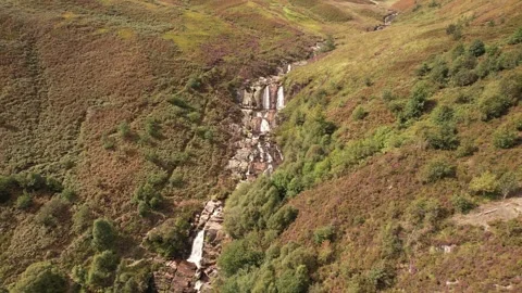 Aerial drone view of waterfall on welsh moorland, Lake Vyrnwy area in summer Stock Footage 336491978