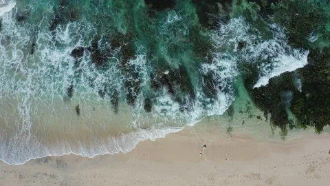 Aerial drone view of waves breaking on a beach shoreline Stock Footage 143511846