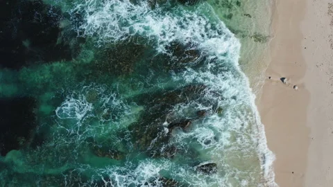 Aerial drone view of waves breaking on a beach shoreline Stock Footage 143513276