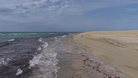 Aerial drone view of waves crashing on a desert beach, Caspian sea, Mangystau Stock Footage 322790780