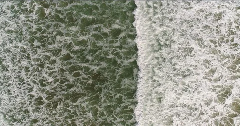 Aerial drone view of waves with foam in green sea Stock Footage 124375512