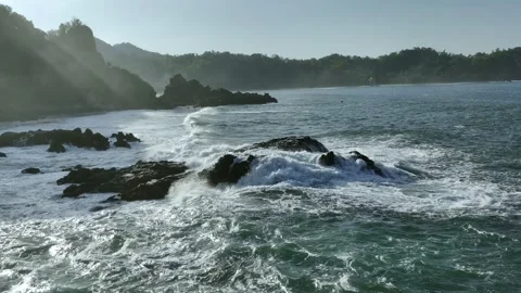 Aerial Drone View of Waves Rolling Across Rocky Shoreline Stock Footage 344831227