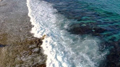Aerial drone view of waves splashing on the beach Stock Footage 137461628