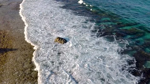 Aerial drone view of waves splashing on the beach Stock Footage 137461834
