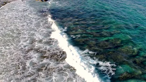 Aerial drone view of waves splashing on the beach Stock Footage 137461859