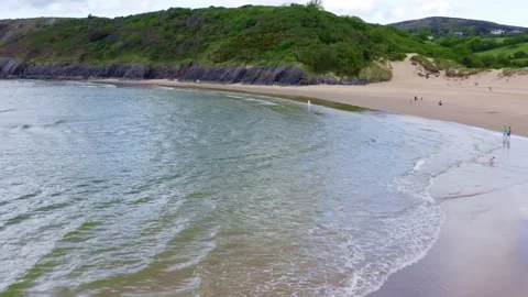 Aerial Drone view of welsh beach known as three cliffs bay during spring sunny Stock Footage 194507765