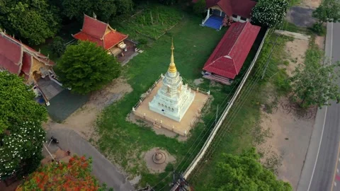 Aerial drone view of white Buddhist pagoda in Thai temple complex Stock Footage 336297552