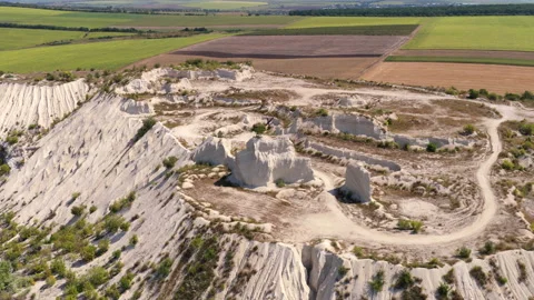 Aerial drone view of White chalk quarry creating an industrial landscape next to Stock Footage 345500882