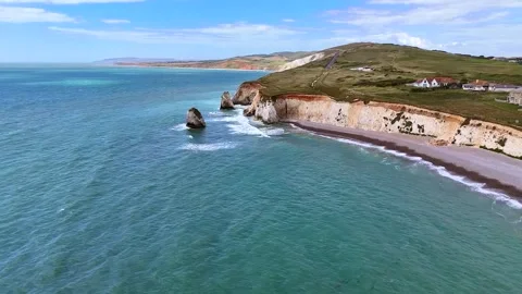 Aerial drone view of white chalk cliffs and turquoise ocean coastline Stock Footage 346323637