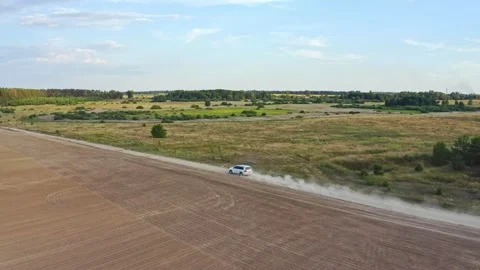 Aerial drone view: White suv car is fast driving on rural road. Drone is foll Stock Footage 219863981