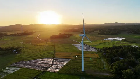 Aerial drone view of a white wind turbine and a second turbine in the distance Stock-Footage 336665074