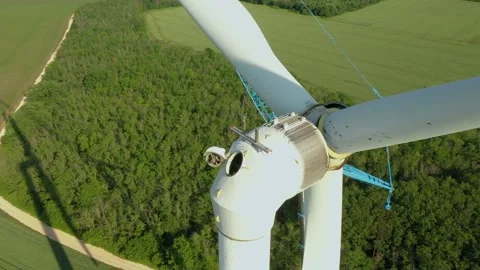 Aerial drone view of a wind farm as industrial maintenance is undergoing Stock Footage 236491624