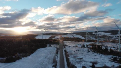 Aerial drone view of wind farm along winter road at sunset, Gaspésie, Canada Stock Footage 330950803