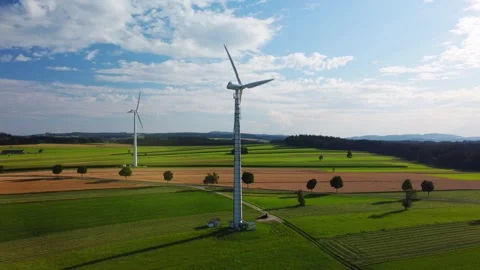Aerial Drone View of Wind Turbines Above Agricultural Fields Under Cloudy Sky Stock Footage 337710604