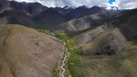 Aerial Drone View of Winding River Valley Surrounded by Rugged Snow Video stock 315073636