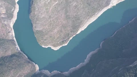 Aerial drone view of a winding river through deep mountain canyons in China Stock Footage 342311675