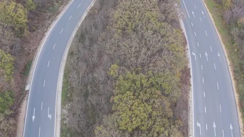 Aerial drone view of winding road through colorful autumn forest landscape Stock Footage 322902014