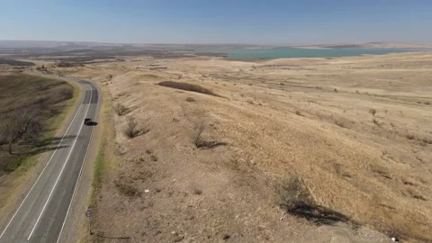 Aerial drone view of a winding road through an arid landscape Stock Footage 337479428