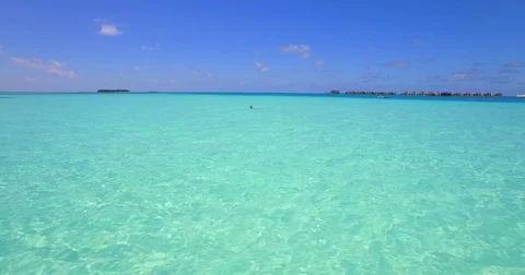 Aerial drone view of a woman floating and swimming on a tropical island. Stock Footage