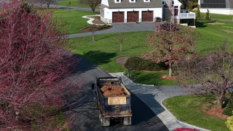 Aerial drone view of work truck transporting yard debris through quiet suburban Stock-Footage 333614724
