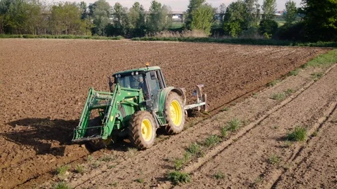 Aerial drone view of a young farmer plowing with tractor Stock Footage 122808433