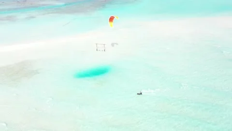 Aerial drone view young man kite surfing in tropical blue waters in Maldives Video stock 239823908