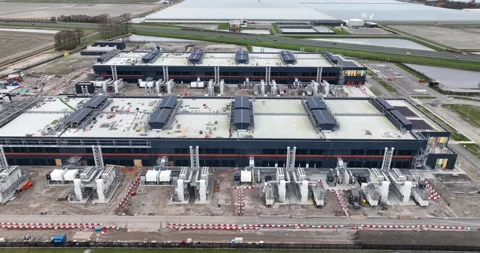 Aerial drone views the construction of a large scale big tech datacenter at Stock Footage 273729196
