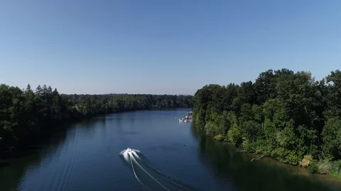 Aerial drone of Willamette River following boat on a sunny blue sky summer day Stock Footage 104819082