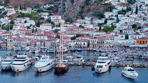 Aerial Drone Zoom View of Hydra Town Harbor With Superyachts and Waterfront at Stock Footage 344065553